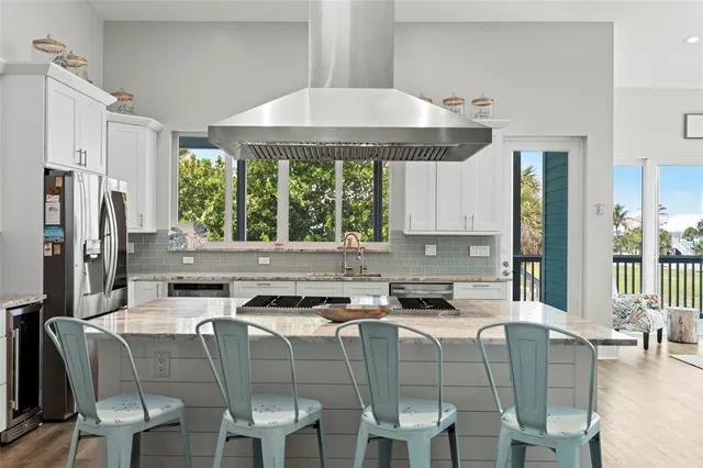 a kitchen with a table chairs stove and cabinets