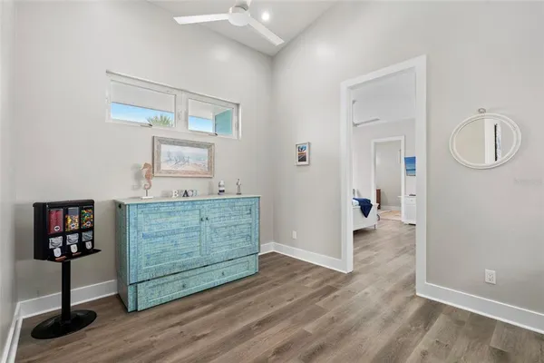 a living room with a bed furniture and a wooden floor
