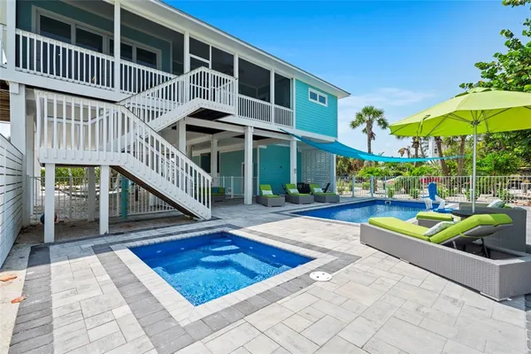 a view of a porch with chairs and backyard