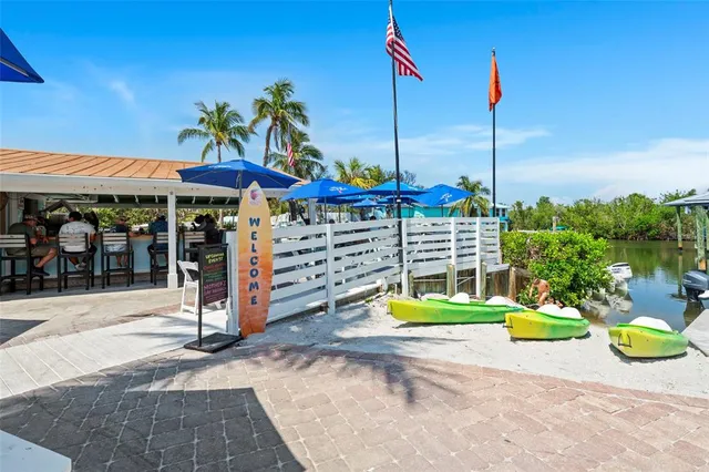 a view of swimming pool with a couch and chairs