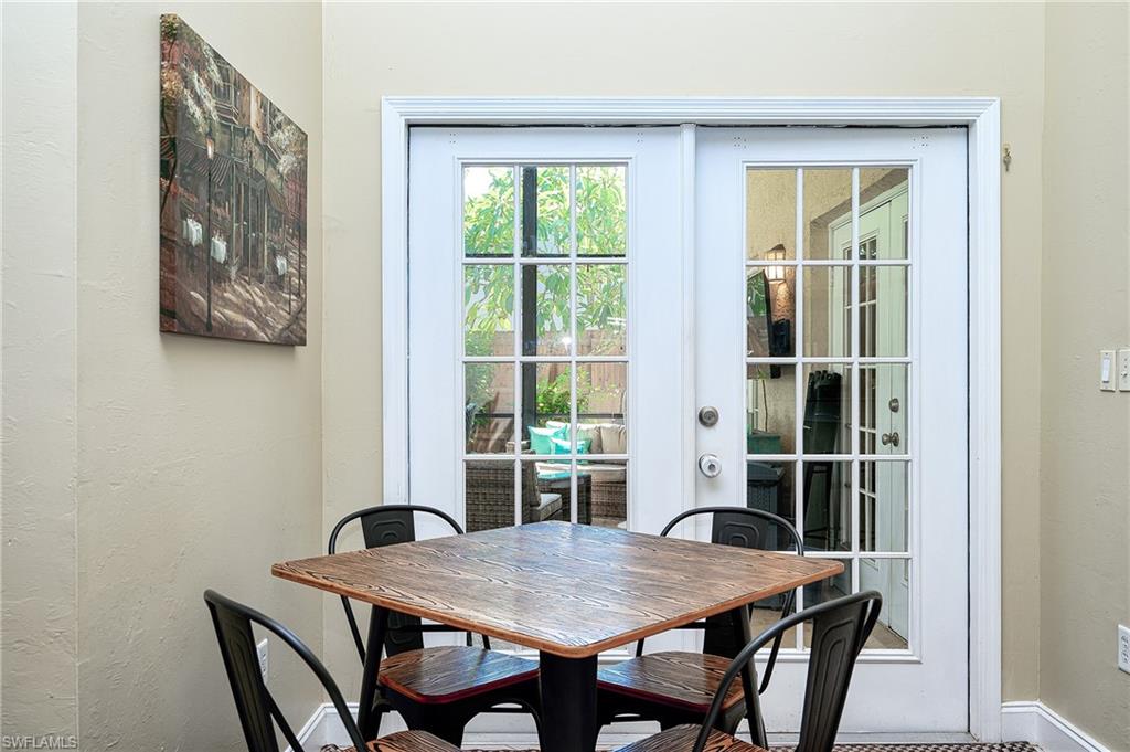 10058 Boca Circle Naples, FL 34109 - Photo 14 of 33 a view of a dining room with a table and chairs