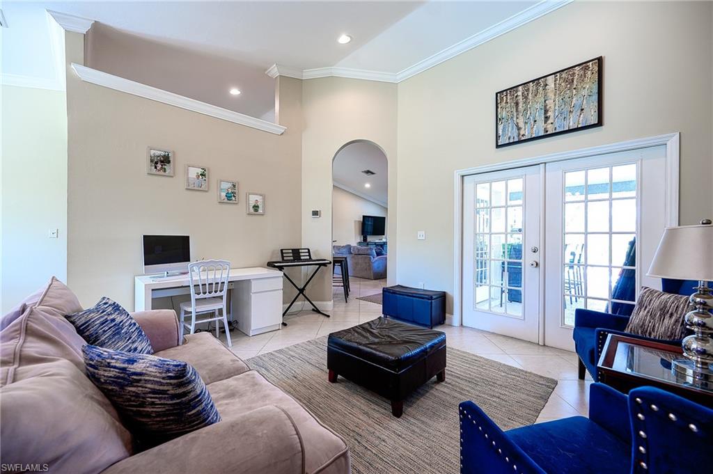 10058 Boca Circle Naples, FL 34109 - Photo 17 of 33 a living room with furniture or couch and a flat screen tv