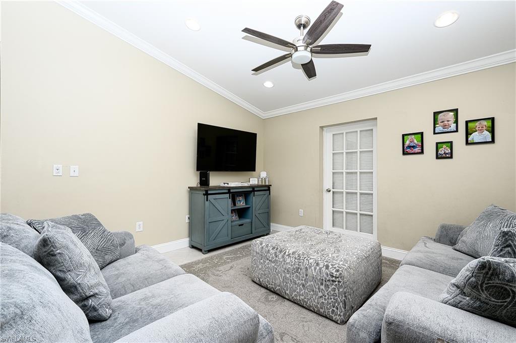 10058 Boca Circle Naples, FL 34109 - Photo 21 of 33 a living room with furniture and a flat screen tv