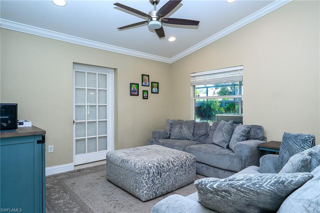 10058 Boca Circle Naples, FL 34109 - Photo 22 of 33 a living room with furniture and a window