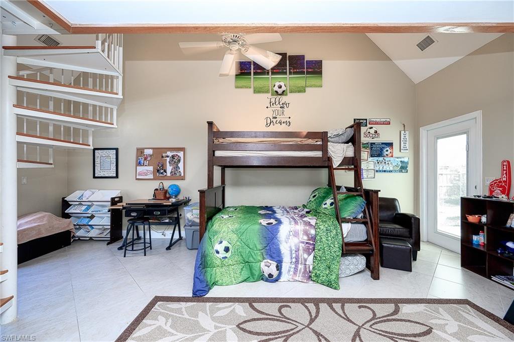 10058 Boca Circle Naples, FL 34109 - Photo 23 of 33 a living room filled with furniture and a table
