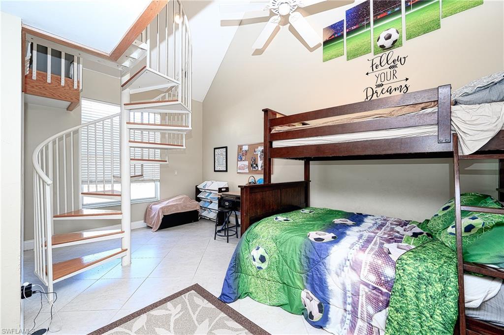 10058 Boca Circle Naples, FL 34109 - Photo 24 of 33 a bedroom with a bed and a window