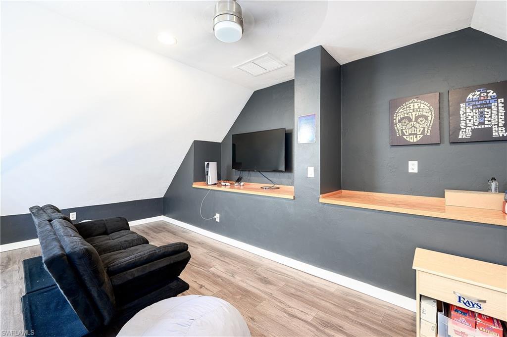 10058 Boca Circle Naples, FL 34109 - Photo 25 of 33 a living room with furniture and a flat screen tv
