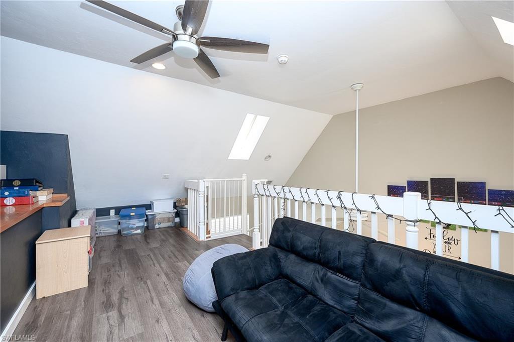10058 Boca Circle Naples, FL 34109 - Photo 26 of 33 a living room with furniture and a wooden floor