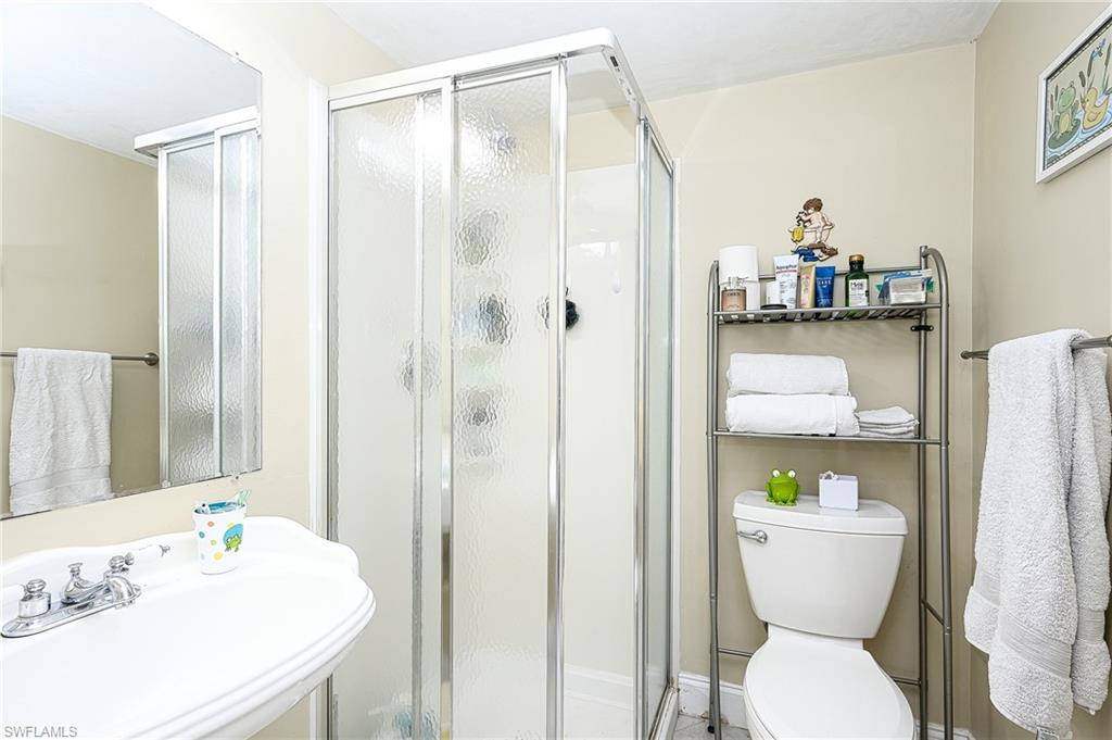 10058 Boca Circle Naples, FL 34109 - Photo 27 of 33 a bathroom with a sink toilet and shower