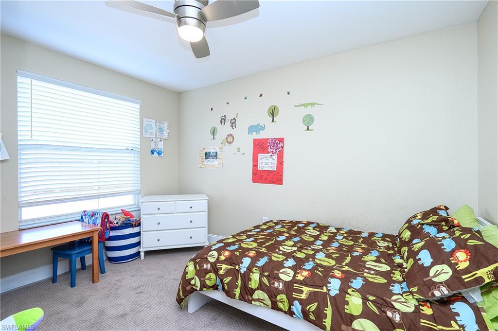 10058 Boca Circle Naples, FL 34109 - Photo 30 of 33 a bedroom with furniture and a window