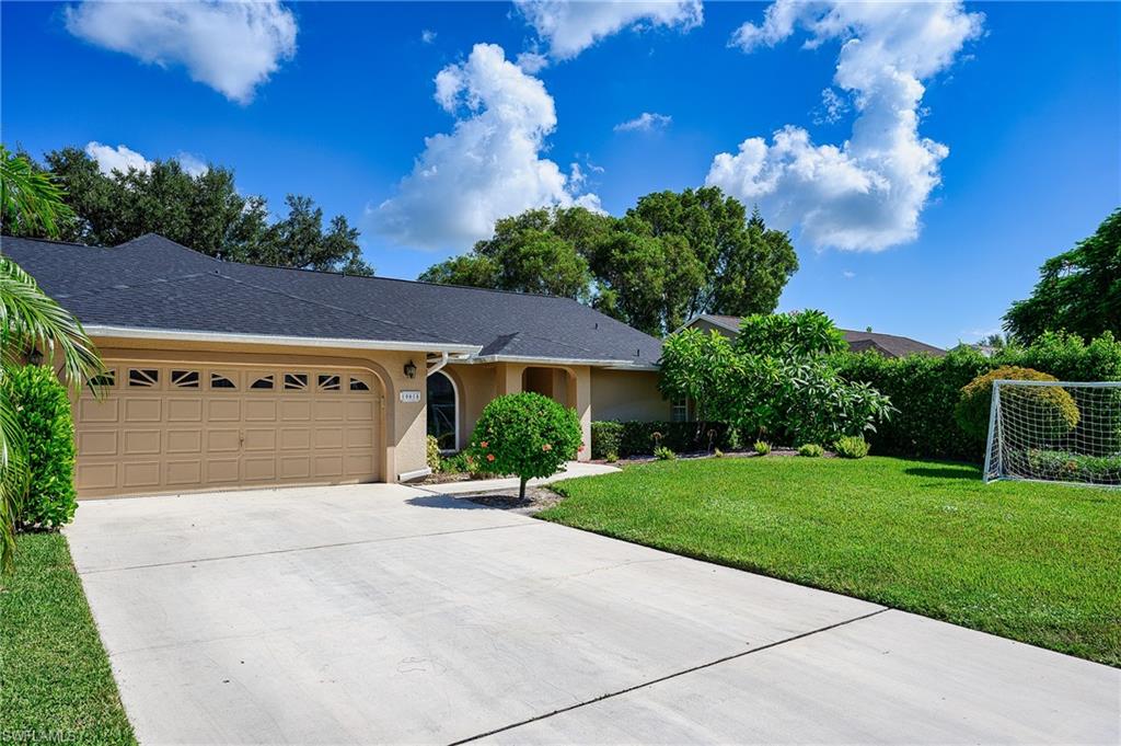 10058 Boca Circle Naples, FL 34109 - Photo 3 of 33 a view of a house with a yard