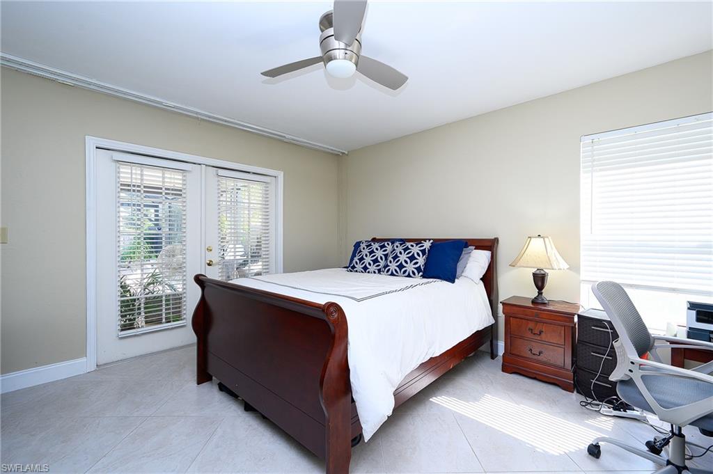 10058 Boca Circle Naples, FL 34109 - Photo 31 of 33 a bedroom with a bed and a desk