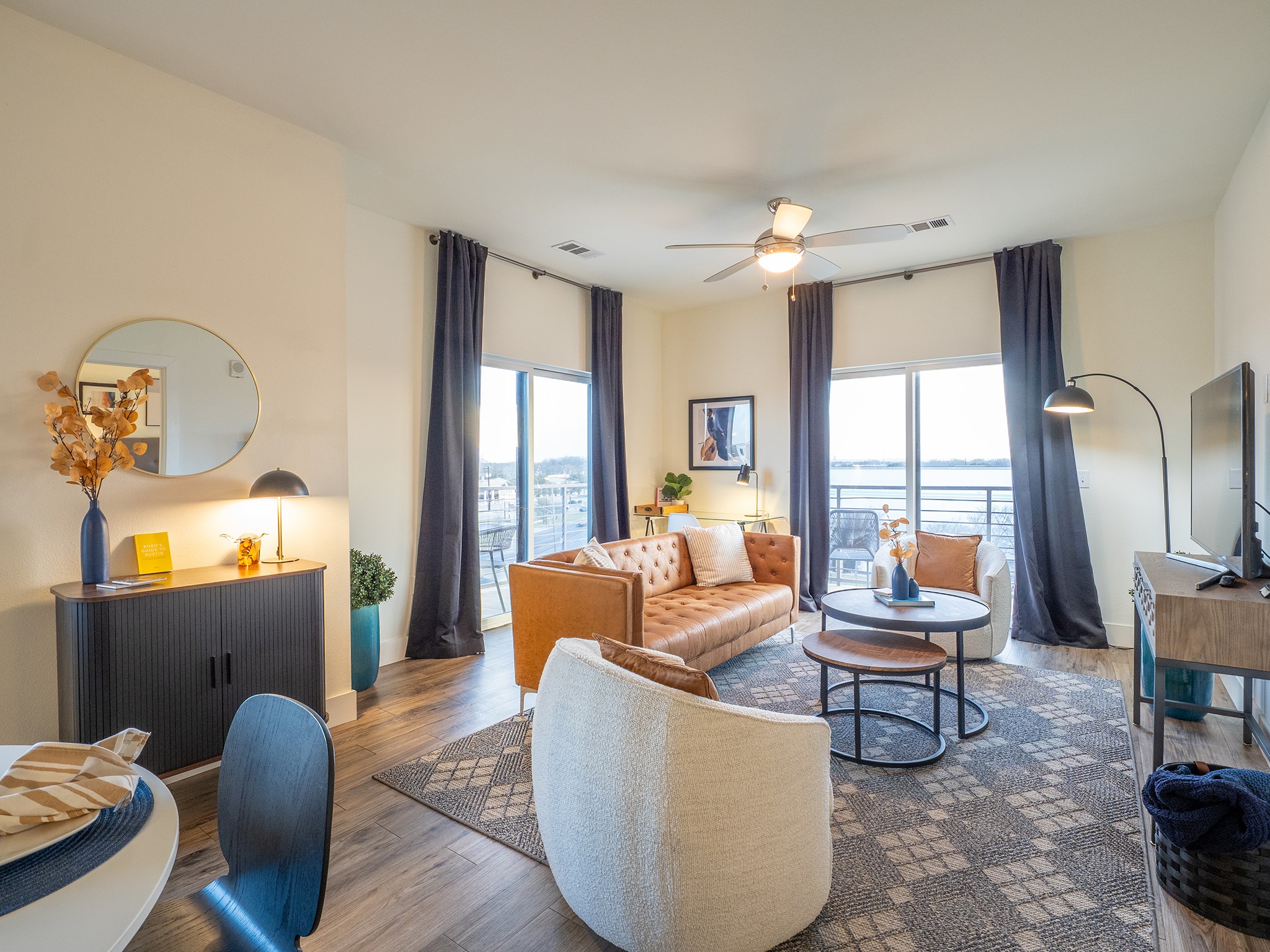 6444 Burnet Road, Unit 509 Austin, TX 78757 - Photo 10 of 32 Step into a sun-filled living space featuring hardwood-style flooring and direct balcony access.