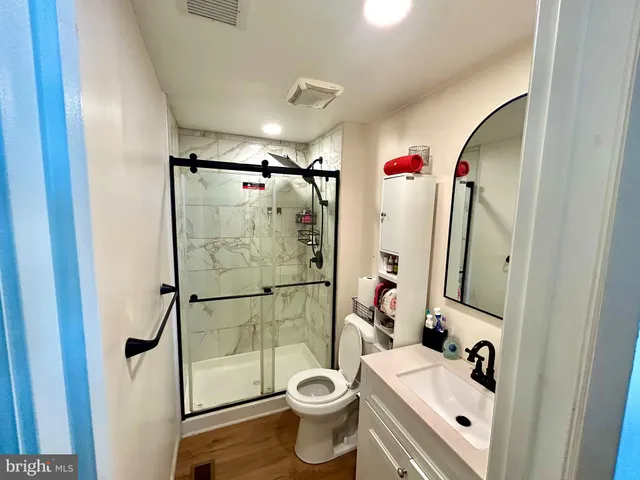 a bathroom with a sink toilet and shower