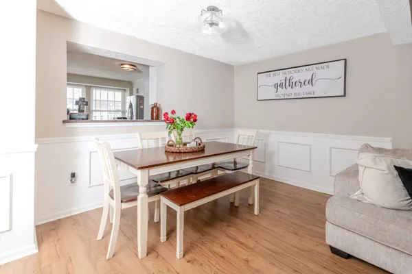 a dining room with wooden floor and breakfast area