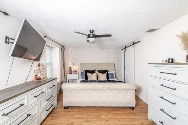 a living room with furniture and a ceiling fan
