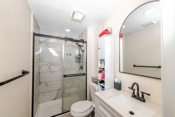 a bathroom with a sink toilet and shower