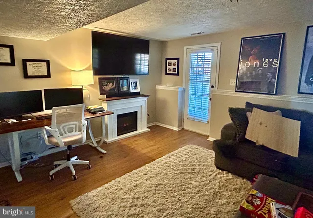a workspace with furniture and a flat screen tv