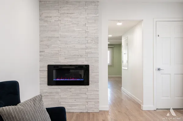 a living room with a fireplace and a rug