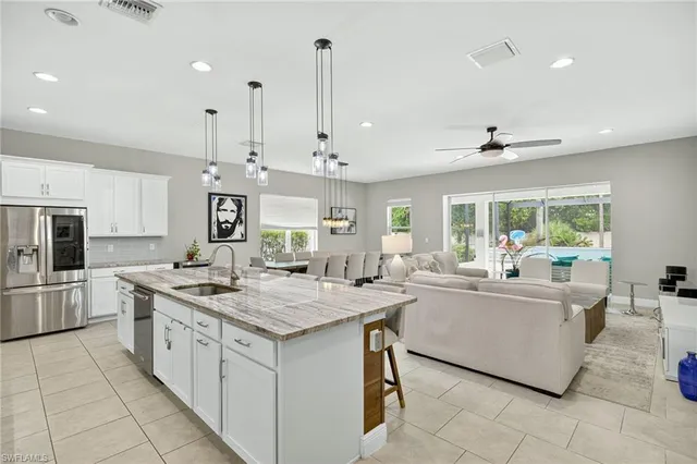 a kitchen with stainless steel appliances granite countertop a sink and a stove