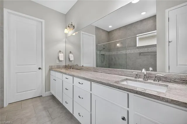 a bathroom with double sink and a mirror