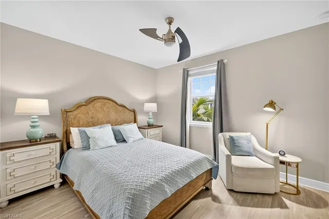 a bedroom with a bed and a lamp