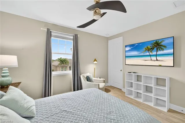 a bedroom with a bed and a painting on the wall