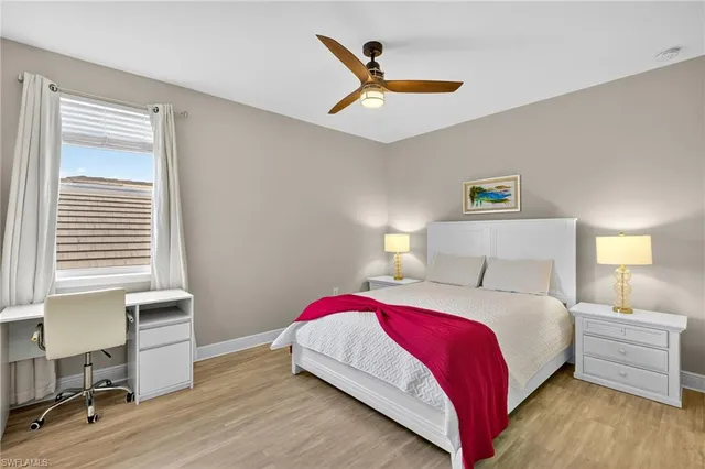 a bedroom with a bed a table and chair