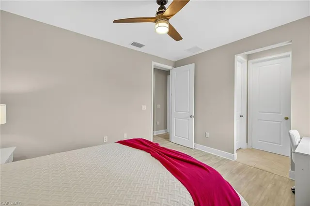 a bedroom with a bed and a chandelier