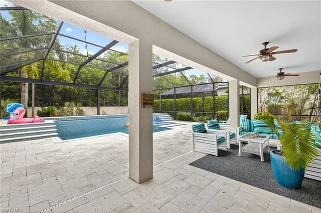 a view of a porch with dining table and chairs