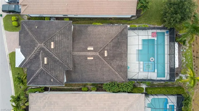 an aerial view of a house with garden space and street view