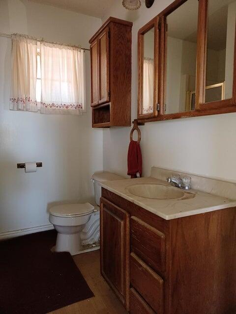 557-435 Center School House Road Bieber, CA 96009 - Photo 18 of 24 a bathroom with a granite countertop toilet sink and mirror