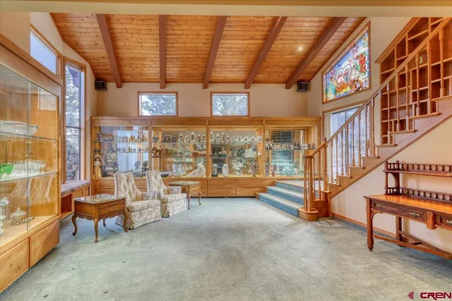 a view of a reading room with lounge chair and a couch