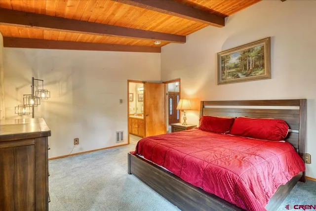 a bedroom with a bed and a potted plant