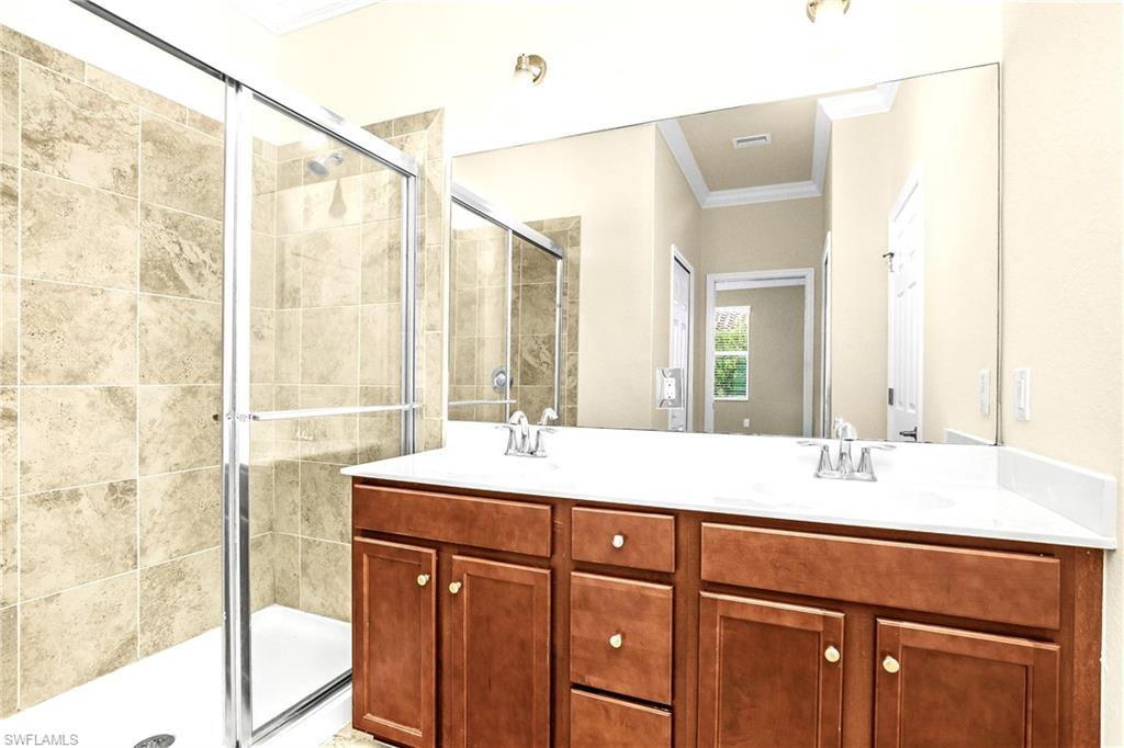 2754 Citrus Street Naples, FL 34120 - Photo 11 of 34 a bathroom with a sink and a mirror