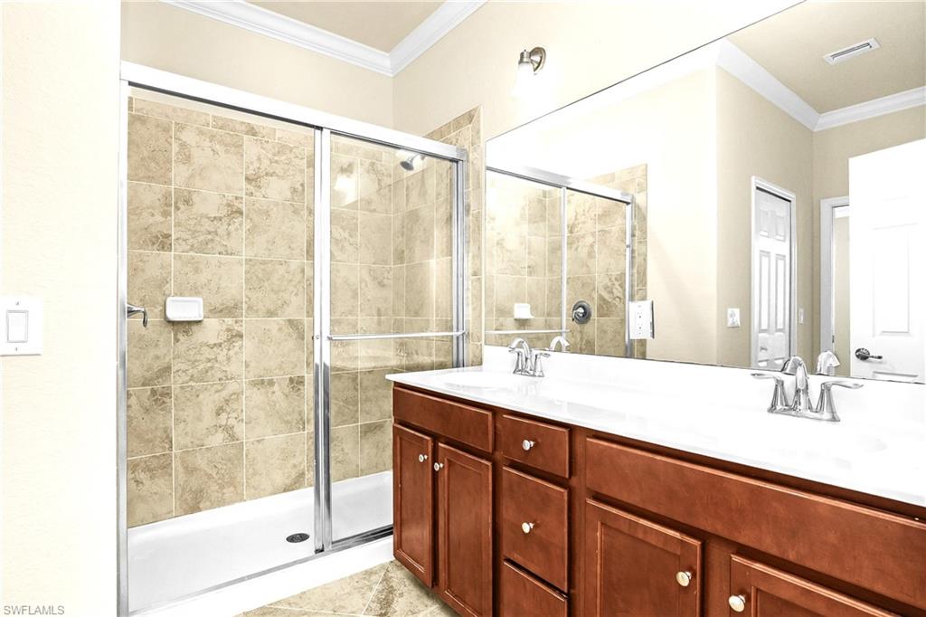 2754 Citrus Street Naples, FL 34120 - Photo 14 of 34 a bathroom with a sink and a mirror