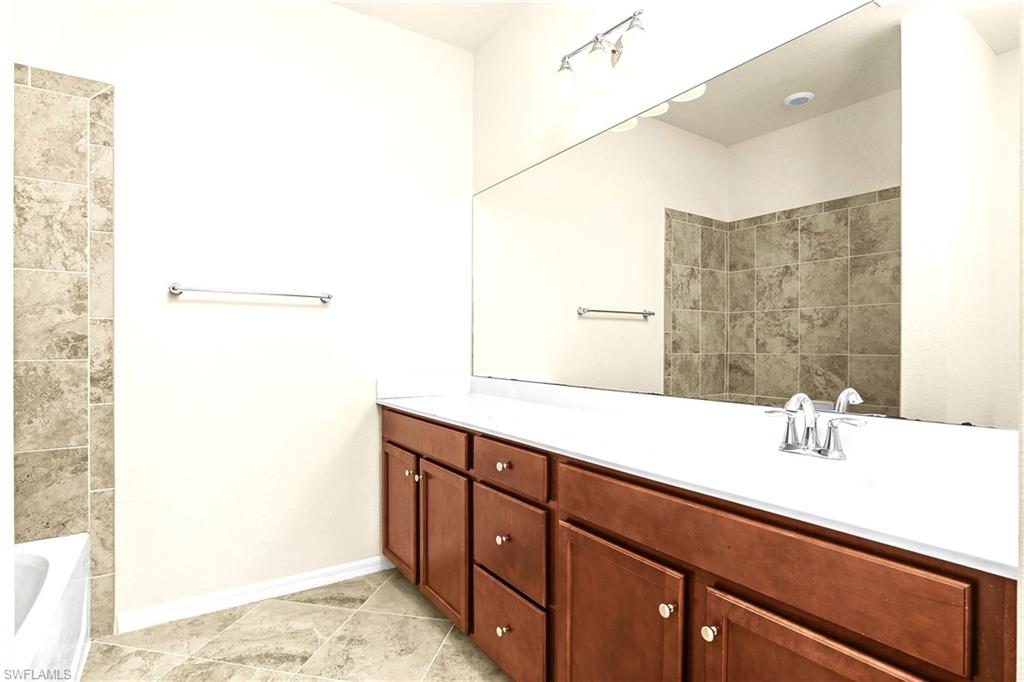 2754 Citrus Street Naples, FL 34120 - Photo 16 of 34 a bathroom with a sink and a mirror