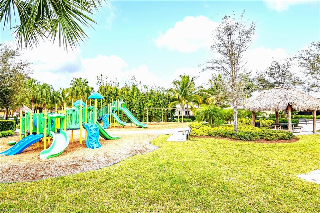 2754 Citrus Street Naples, FL 34120 - Photo 27 of 34 a view of a swimming pool with an outdoor space and seating area