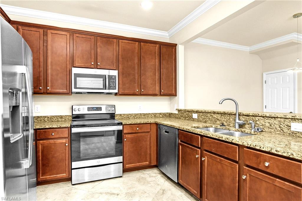 2754 Citrus Street Naples, FL 34120 - Photo 3 of 34 a kitchen with granite countertop wooden cabinets and stainless steel appliances