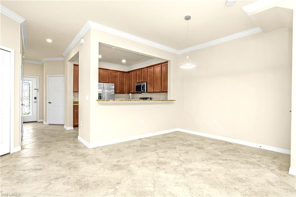 2754 Citrus Street Naples, FL 34120 - Photo 7 of 34 a view of kitchen and kitchen with granite countertop cabinets