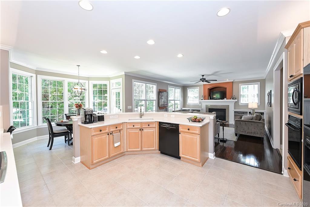 3501 Rhett Butler Place Charlotte, NC 28270 - Photo 12 of 48 a large white kitchen with a large window and stainless steel appliances