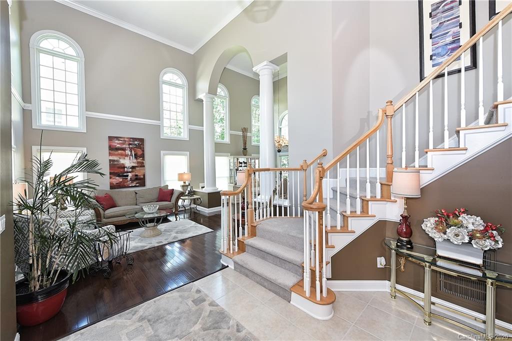 3501 Rhett Butler Place Charlotte, NC 28270 - Photo 3 of 48 a living room with lots of furniture and a floor to ceiling window