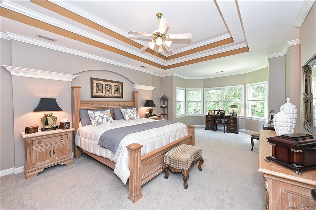 3501 Rhett Butler Place Charlotte, NC 28270 - Photo 24 of 48 a spacious bedroom with bed and a chandelier