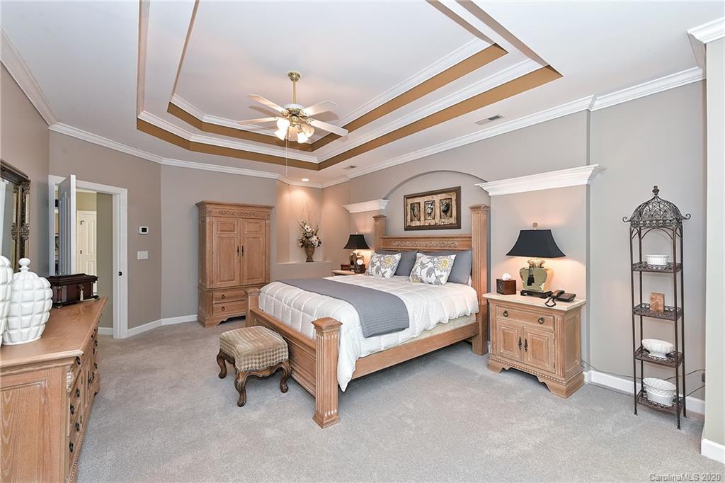 3501 Rhett Butler Place Charlotte, NC 28270 - Photo 25 of 48 a spacious bedroom with a bed and a chandelier