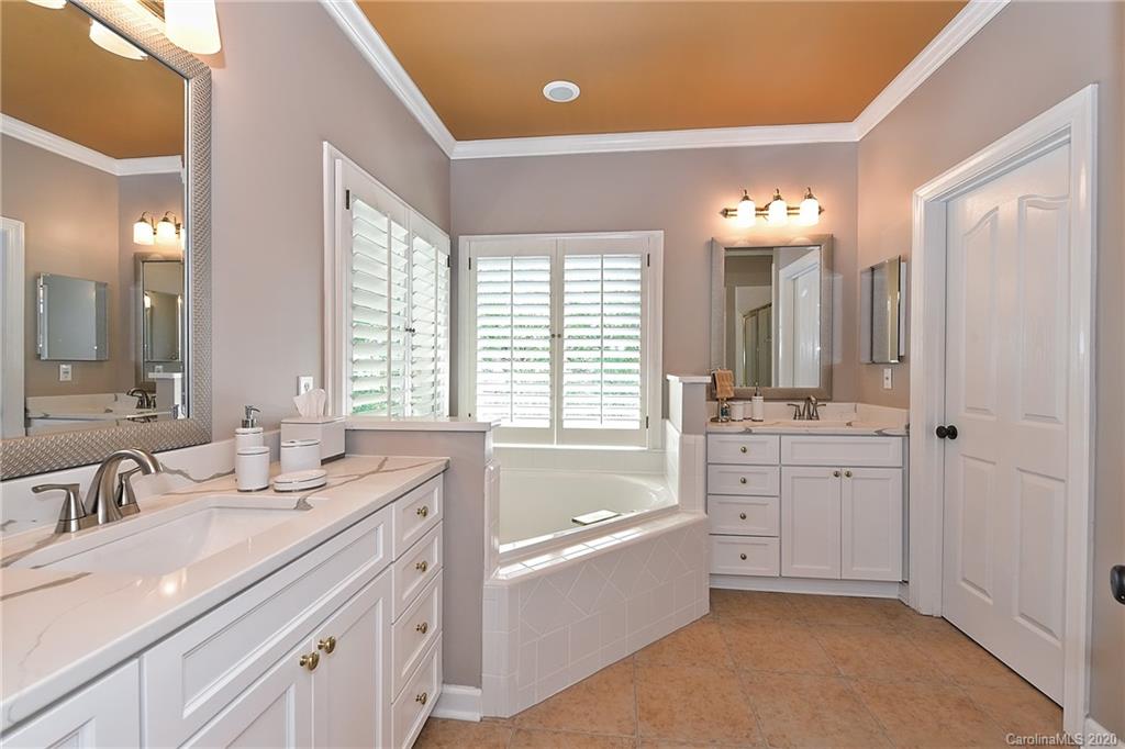 3501 Rhett Butler Place Charlotte, NC 28270 - Photo 27 of 48 a bathroom with a granite countertop tub a double vanity sink a window and a mirror