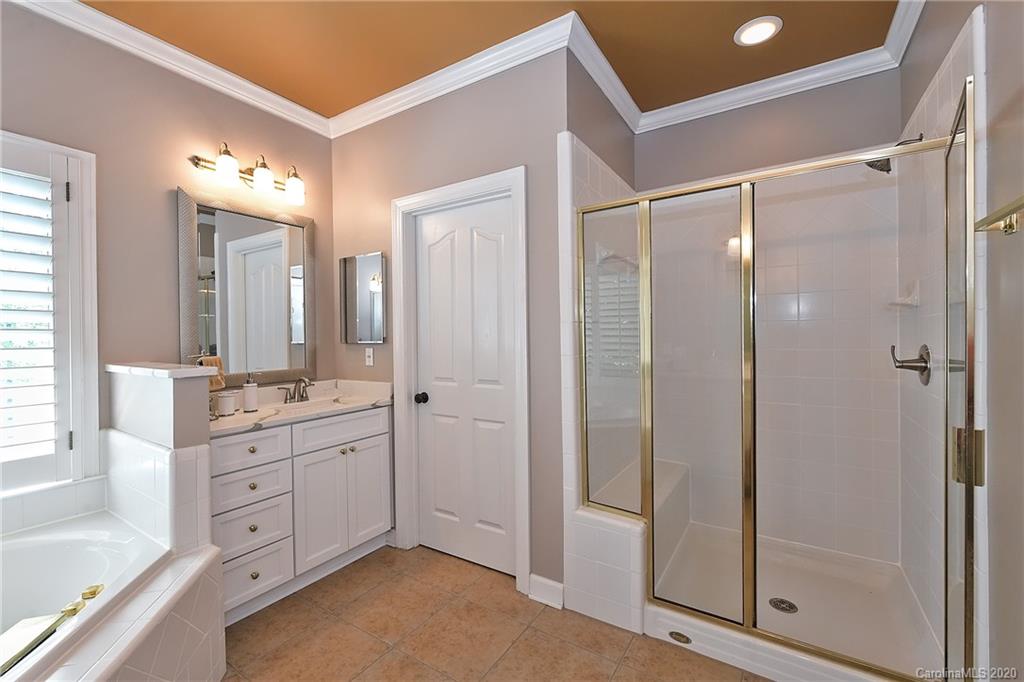 3501 Rhett Butler Place Charlotte, NC 28270 - Photo 28 of 48 a spacious bathroom with a shower sink and mirror