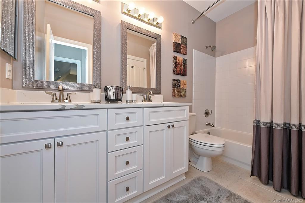 3501 Rhett Butler Place Charlotte, NC 28270 - Photo 30 of 48 a bathroom with a toilet sink double vanity and mirror