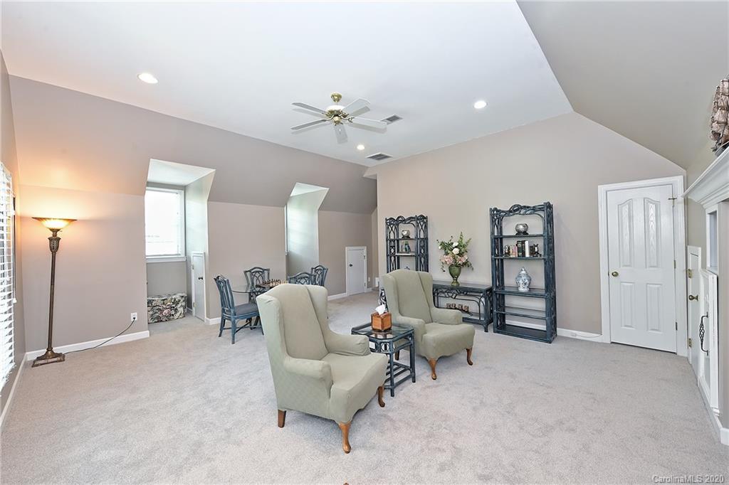 3501 Rhett Butler Place Charlotte, NC 28270 - Photo 34 of 48 a living room with furniture and a chandelier
