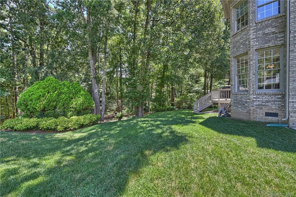 3501 Rhett Butler Place Charlotte, NC 28270 - Photo 43 of 48 a view of a backyard with table and chairs and large trees