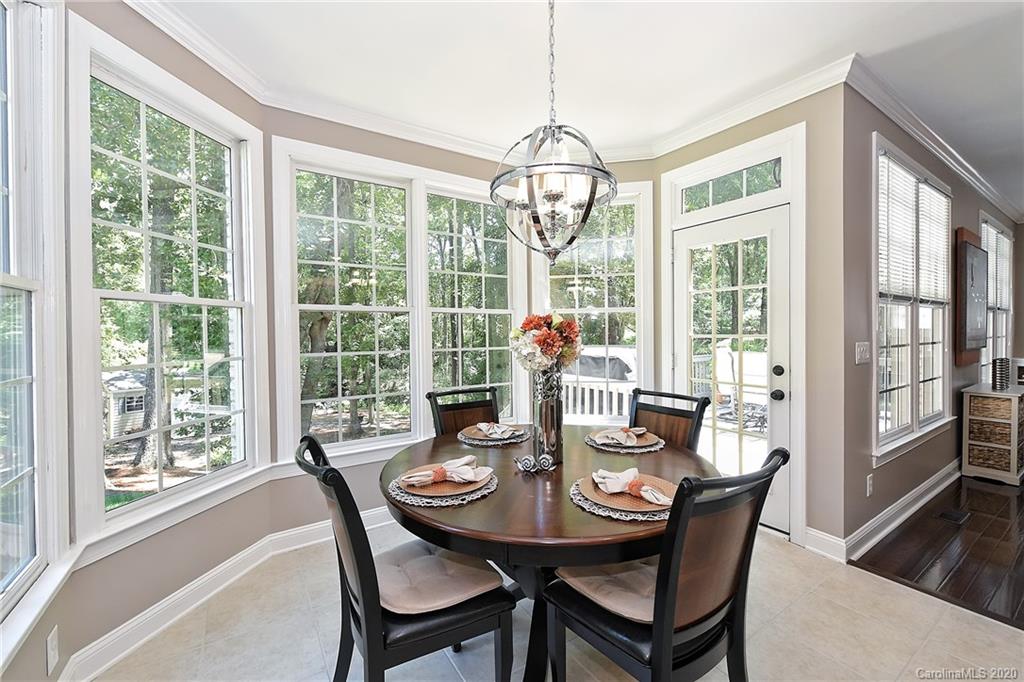 3501 Rhett Butler Place Charlotte, NC 28270 - Photo 8 of 48 a view of a dining room with furniture large windows and wooden floor